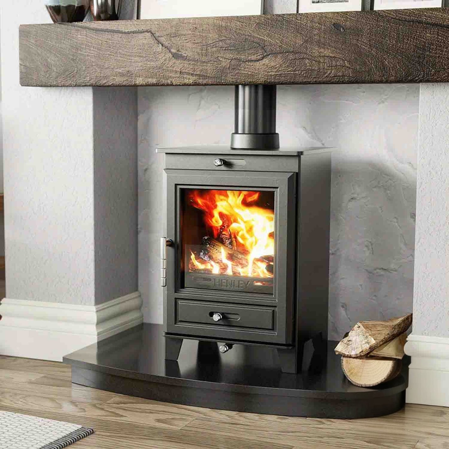 Glenwood stove lit in natural surround with logs on the side